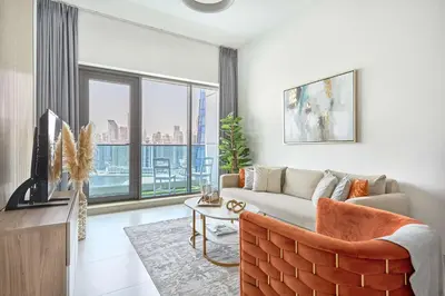 a living room with a couch and a large window at Frank Porter - The Bay in Dubai