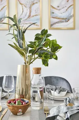 a table with a vase and a bowl of fruit at Frank Porter - The Bay in Dubai