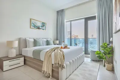 a bedroom with a large bed and a large window at Frank Porter - The Bay in Dubai