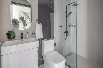 a bathroom with a toilet and a sink and a shower at Frank Porter - Opalz By Danube - Tower 2 in Dubai