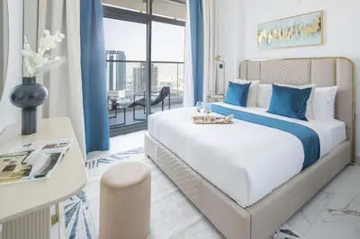 a bedroom with a large bed with blue accents at Frank Porter - Opalz By Danube - Tower 2 in Dubai
