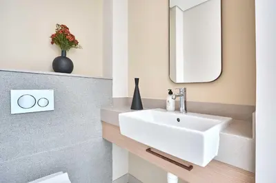 a bathroom with a white sink and a mirror at Frank Porter - Vida Dubai Mall Tower 2 in Dubai