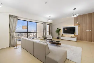 a living room with a couch and a tv at Rimal 5, JBR - 3 Bedroom with Maid's Room Apartment - Allsopp & Allsopp in Dubai