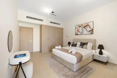 a bedroom with a large white bed and a table at Rimal 5, JBR - 3 Bedroom with Maid's Room Apartment - Allsopp & Allsopp in Dubai