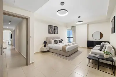a living room with a bed and a couch at Rimal 5, JBR - 3 Bedroom with Maid's Room Apartment - Allsopp & Allsopp in Dubai