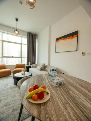 a living room with a table with fruit on it at Stunning 2bd marina views prime location high floor in Dubai