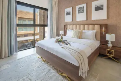 a bedroom with a large bed and a large window at Frank Porter - Eleganz 5 By Danube in Dubai