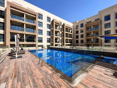 a swimming pool in front of a building at Frank Porter - Eleganz 5 By Danube in Dubai