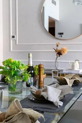 a glass table with a plate of food and a mirror at Frank Porter - Eleganz 5 By Danube in Dubai