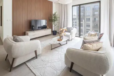 a living room with two chairs and a television at Frank Porter - Rosewater at Creek Beach 3 in Dubai