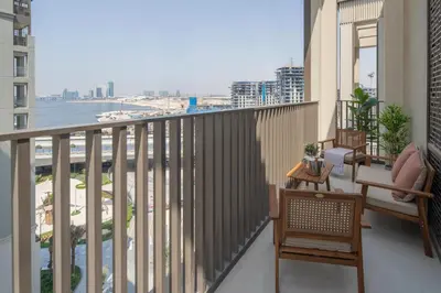 a balcony with chairs and a view of the city at Frank Porter - Rosewater at Creek Beach 3 in Dubai