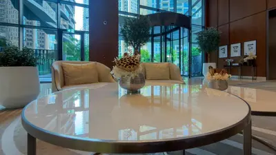 a glass table in a lobby with a couch and chairs at Luxury 2BR at Address Opera with Burj Khalifa view in Dubai