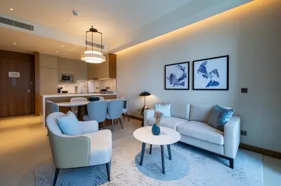 a living room with a couch and a table at Luxury 2BR at Address Opera with Burj Khalifa view in Dubai