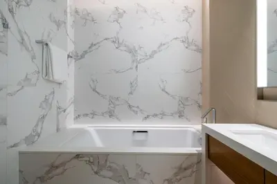 a white bathroom with a tub and a sink at Luxury 2BR at Address Opera with Burj Khalifa view in Dubai