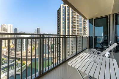 a balcony with a bench and a view of a city at Beachfront Vibe 2BR APT - Walk to JBR & Bluewaters in Dubai