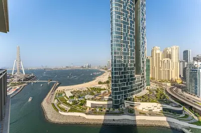 an aerial view of a city with a tall building at Beachfront Vibe 2BR APT - Walk to JBR & Bluewaters in Dubai