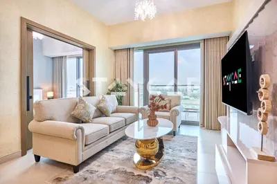 a living room with a couch and a table at Staycae Holiday Homes Golf Gate - Damac Hills in Dubai