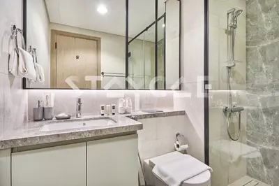 a bathroom with a toilet and a sink and a shower at Staycae Holiday Homes Golf Gate - Damac Hills in Dubai