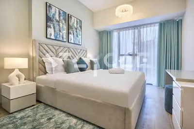 a bedroom with a large bed and a large window at Staycae Holiday Homes Golf Gate - Damac Hills in Dubai