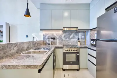 a kitchen with white cabinets and a sink at Staycae Holiday Homes Golf Gate - Damac Hills in Dubai