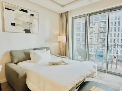a hotel room with a bed and a large window at Stylish Stay 2 Bedroom Minutes from Burj Khalifa in Dubai