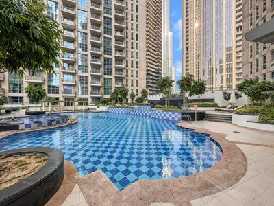 a large swimming pool in a city with tall buildings at Stylish Stay 2 Bedroom Minutes from Burj Khalifa in Dubai