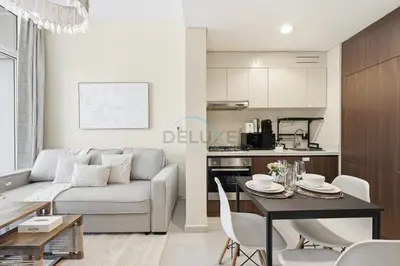 a living room with a couch and a table at Located Near Dubai Mall, Burj Khalifa and Dubai Canal, with Easy Access to Dubai Metro - Vera Tower, Business Bay by Deluxe Holiday Homes in Dubai