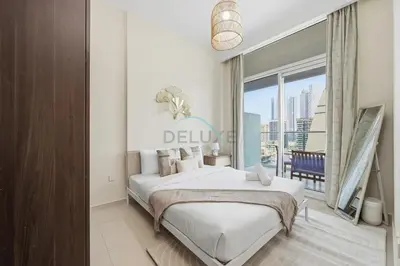 a bedroom with a large bed and a large window at Located Near Dubai Mall, Burj Khalifa and Dubai Canal, with Easy Access to Dubai Metro - Vera Tower, Business Bay by Deluxe Holiday Homes in Dubai