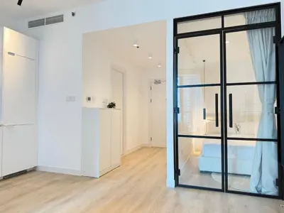 a room with white walls and a glass door at Marina Luxury 2 Bedroom Boutique Apartment in Dubai