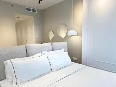 a bedroom with a bed with two pillows and two mirrors at Marina Luxury 2 Bedroom Boutique Apartment in Dubai