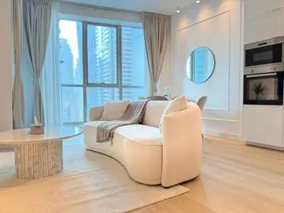 a living room with a white couch and a table at Marina Luxury 2 Bedroom Boutique Apartment in Dubai