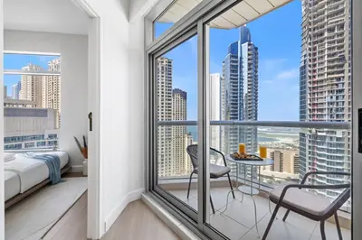 a bedroom with a view of a city at High-Floor 2BR in Dubai Marina with Balcony in Dubai