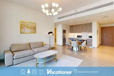 a living room with a couch and a table at Vacationer l Infinity Pool, Beach Access l 1 Bed in Beach Vista in Dubai