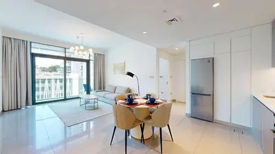 a kitchen and living room with a table and chairs at Vacationer l Infinity Pool, Beach Access l 1 Bed in Beach Vista in Dubai