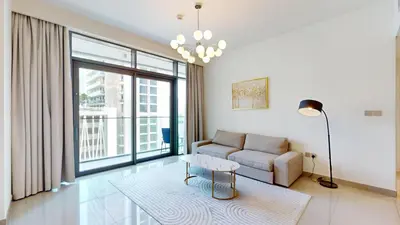 a living room with a couch and a table at Vacationer l Infinity Pool, Beach Access l 1 Bed in Beach Vista in Dubai