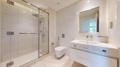 a bathroom with a shower and a toilet and a sink at Vacationer l Infinity Pool, Beach Access l 1 Bed in Beach Vista in Dubai