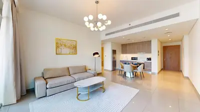 a living room with a couch and a table at Vacationer l Infinity Pool, Beach Access l 1 Bed in Beach Vista in Dubai