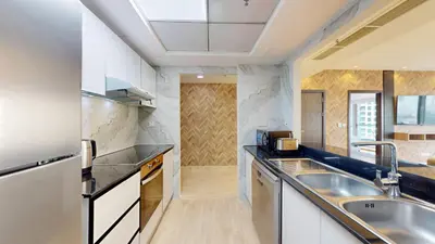 a kitchen with white cabinets and a sink at Vacationer l 1 Bedroom Stunning Marina Skyline l Free Pool, Gym Access in Dubai