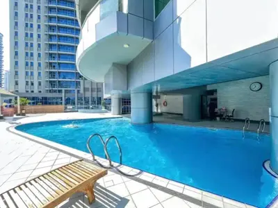 a swimming pool in the middle of a building at Vacationer l 1 Bedroom Stunning Marina Skyline l Free Pool, Gym Access in Dubai