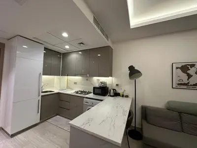 a kitchen with a white counter top in a room at Stunning 1 Bed in Meydan in Dubai