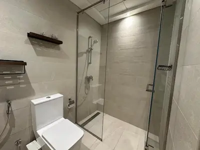 a bathroom with a toilet and a glass shower at Stunning 1 Bed in Meydan in Dubai