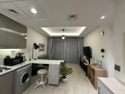 a kitchen with a sink and a desk in a room at Stunning 1 Bed in Meydan in Dubai