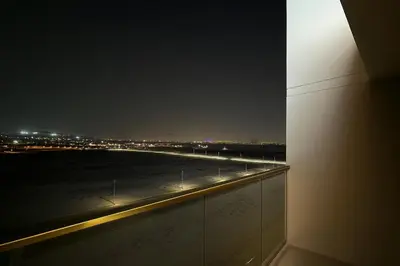 a view of a runway at night from a building at Stunning 1 Bed in Meydan in Dubai