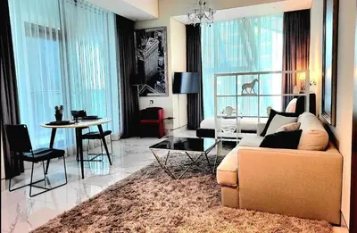 a living room with a couch and a table at Stylish Studio in J One, near Burj Khalifa, Mall in Dubai