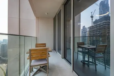 a balcony with a table and chairs on a building at Forte Tower 2 - 3 Bedroom with Maid's Room Apartment - Allsopp & Allsopp in Dubai