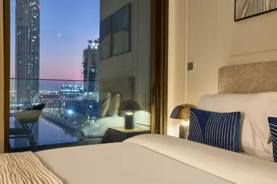 a hotel room with a bed and a view of a city at Modern Studio in Business Bay with Pool, Gym & Canal View in Dubai