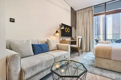 a living room with a couch and a bed at Modern Studio in Business Bay with Pool, Gym & Canal View in Dubai