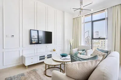 a living room with a couch and a tv at Frank Porter - Azizi Park Avenue in Dubai