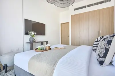 a bedroom with a bed and a television in it at Frank Porter - Azizi Park Avenue in Dubai