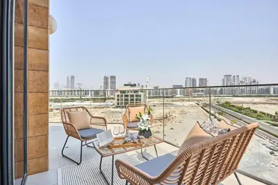 a balcony with chairs and a view of a city at Frank Porter - Azizi Park Avenue in Dubai